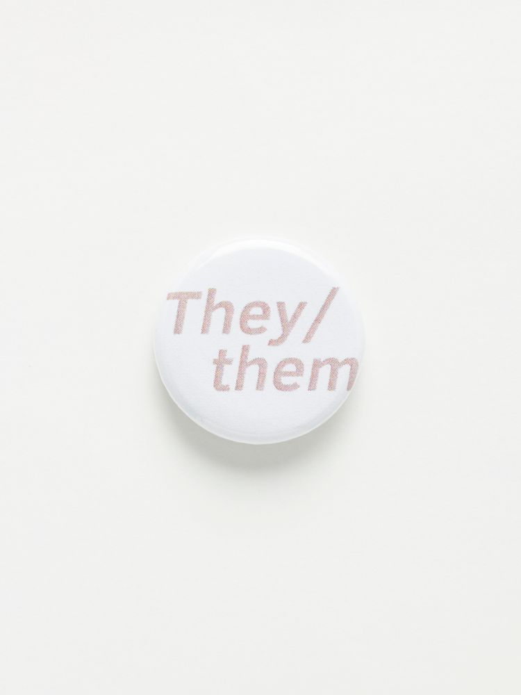 Small badge with they and them pronouns displayed.