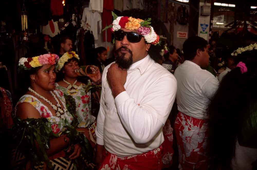 Members of a Tuvalu dance group, focused on a man in sunglasses.