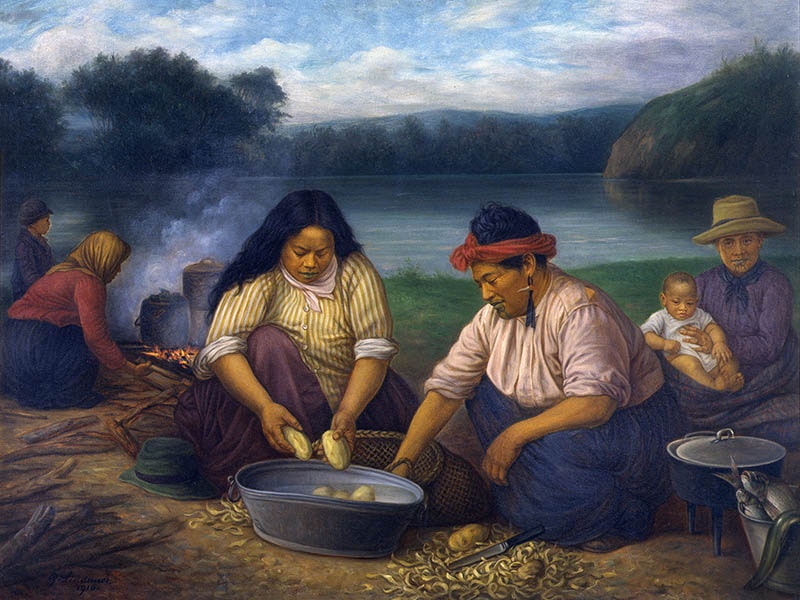 Māori women and children on riverbank peeling potatoes