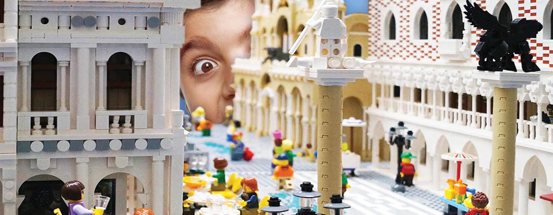 A boy looks at a LEGO town