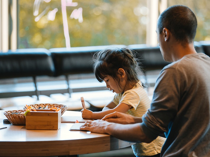 Whānau Day with DOC, 2020. Photo by Abbie Dorrington. Te Papa (162336) A man and child are sitting at a table doing an art activity.