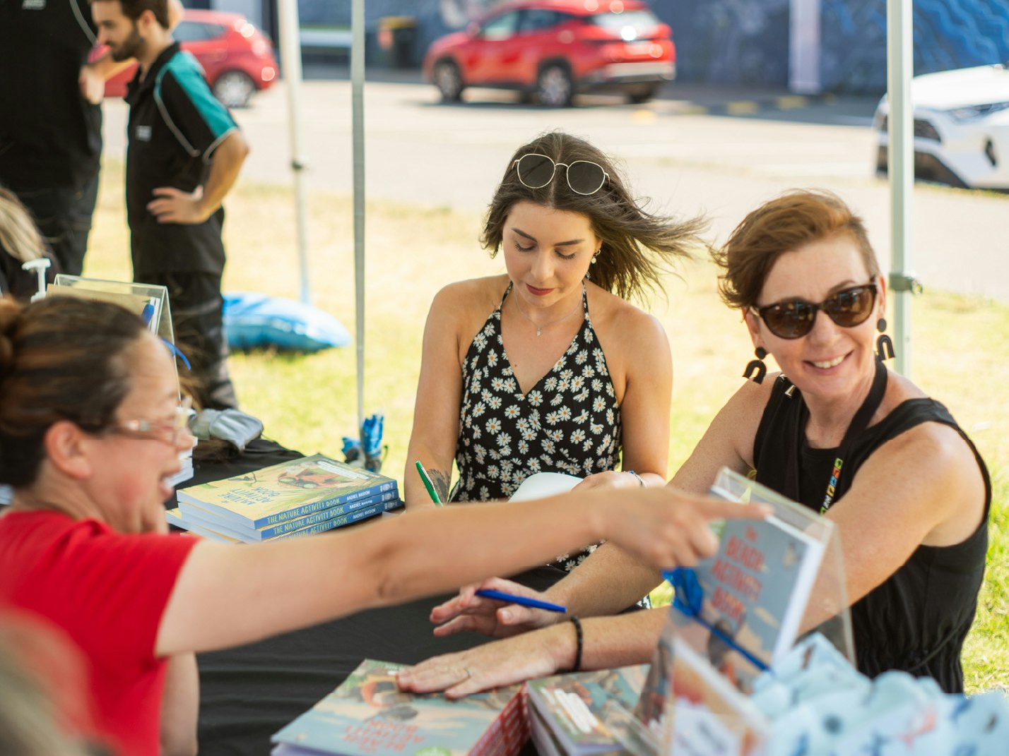 Pippa Keel Situ and Rachel Haydon at the launch of The Beach Activity Book in 2024 Three women sitting outside at a table with books on it