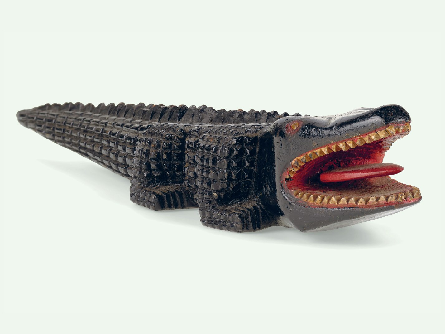 Alligator, 1945, TP GH023139, purchased 2012. Wooden carved alligator on a light green background