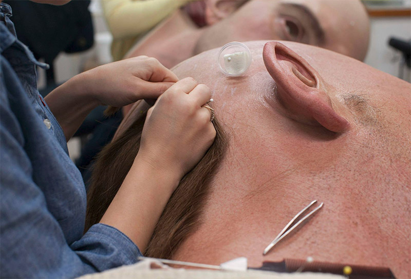 Individual hairs are added to the head of a giant