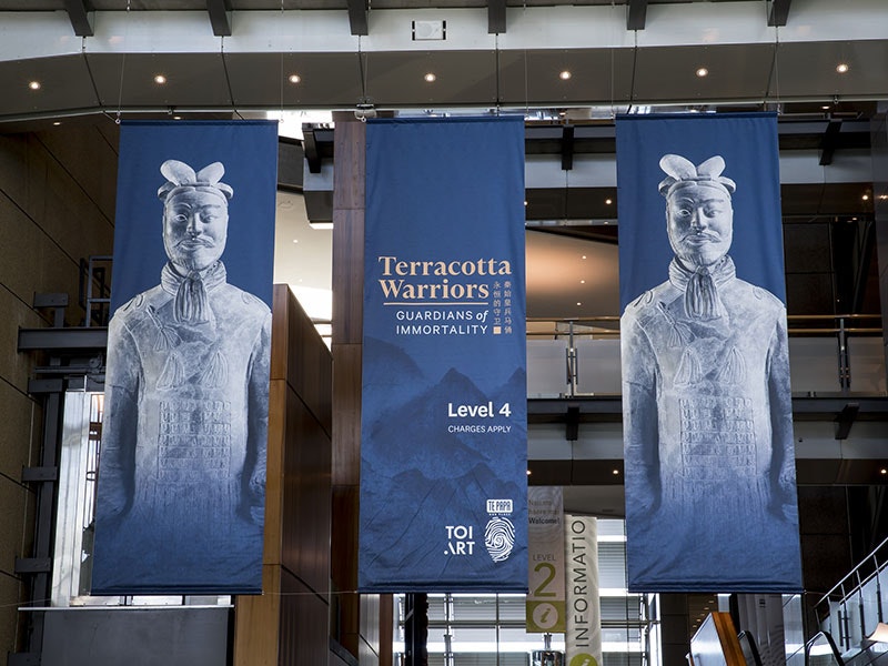 Banners advertising the Terracotta Warriors exhibition hang above the Te Papa entrance foyer