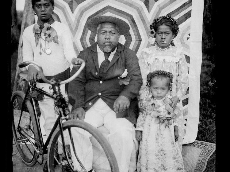 Family group, circa 1910, Cook Islands, by George Crummer. Te Papa (B.028290) Children sit with their grandfather