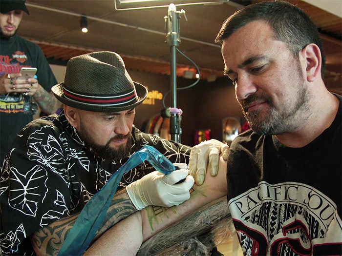 A man receiving a Samoan tatoo in Te Papa