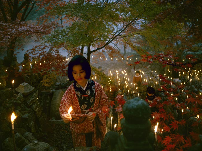 ’Offerings to the unknown dead, Kyoto’ [Toshi Satow offering a candle]. Taken for a series on Japan for ’Life’, 1964, Kyoto, by Brian Brake. Gift of Wai Man Lau, 2010. Te Papa (CT.059863)