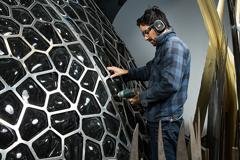 A man building part of the Bugs Lab exhibition