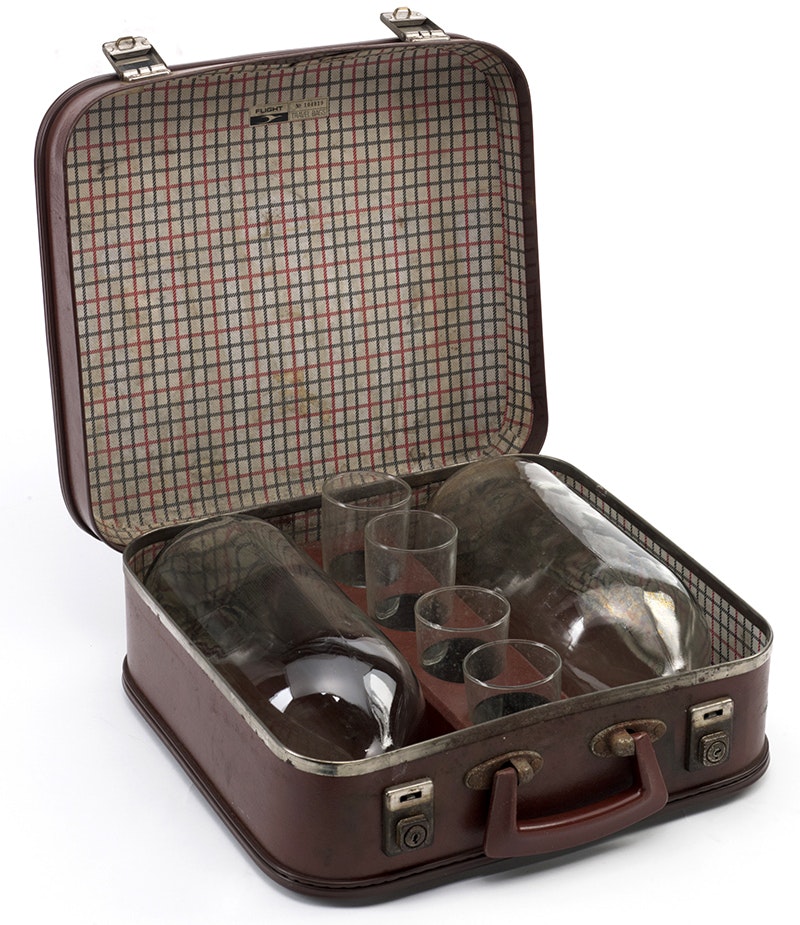 Two big bottles and four glasses in a born leather case with checked lining