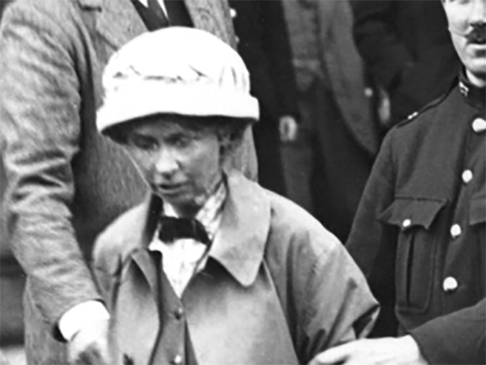 Frances Parker is escorted from Ayr Sheriff Court, Scotland, 1914.