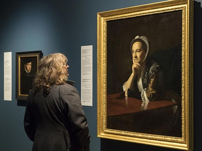 Visitor looks at painting of Mrs Humphrey Devereux, in European Splendour exhibition. Mike O'Neill © Te Papa. Looking at painting in gallery