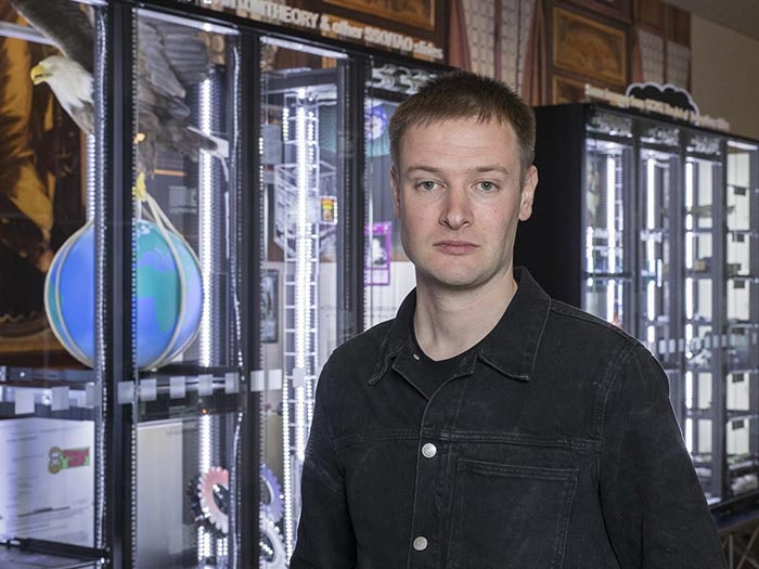 Simon Denny Secret Power at Te Papa horizontal portrait photo credit Mike O'Neill Te Papa Portrait of Simon Denny