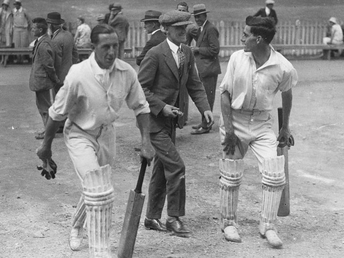 Men walking away from cricket ground