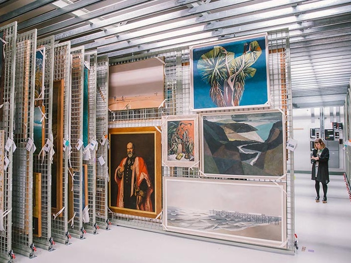 A peek inside the National Art Collection vault with curator Chelsea Nichols to the right, 2016. Te Papa A look inside the art storeroom