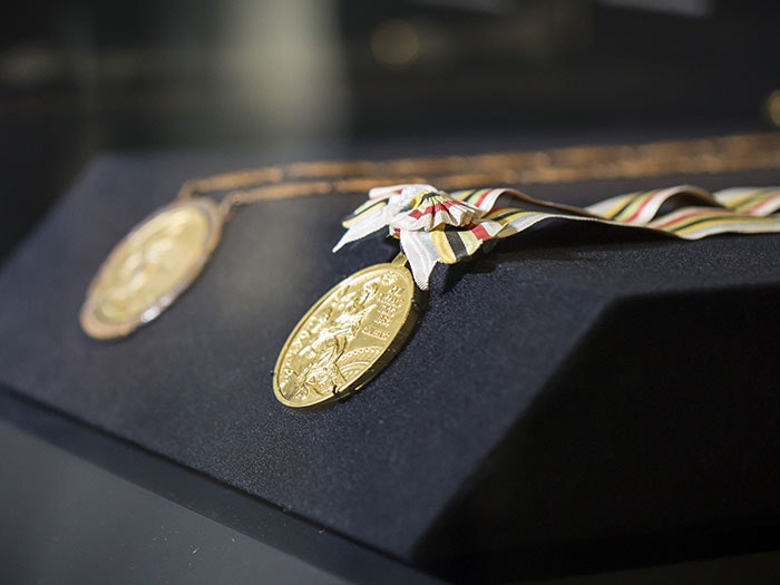 Close up of medals on display during Peter Snell: Medal-Winning Magic, 2017. Te Papa img_8670-700x525.jpg