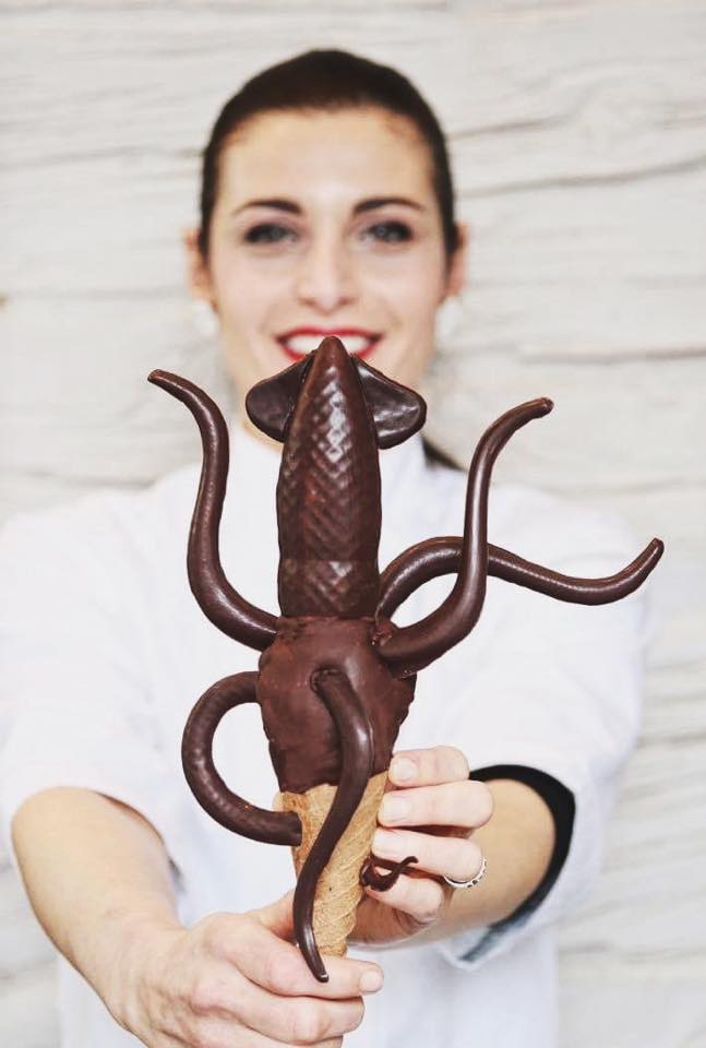 Woman holds an ice cream shaped like a squid