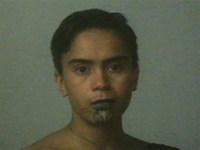 Still from video 'Lisa Reihana: Wog Features', 1990. Auckland Art Gallery Lisa Reihana with a painted tattoo on her chin