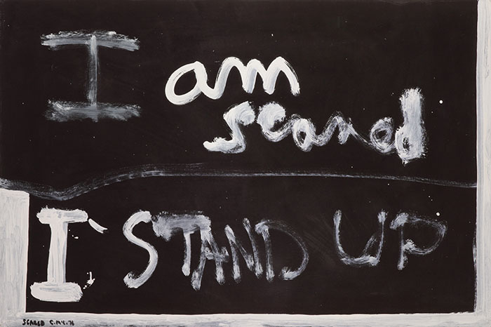 White painted text on black background "I am scared I stand up"