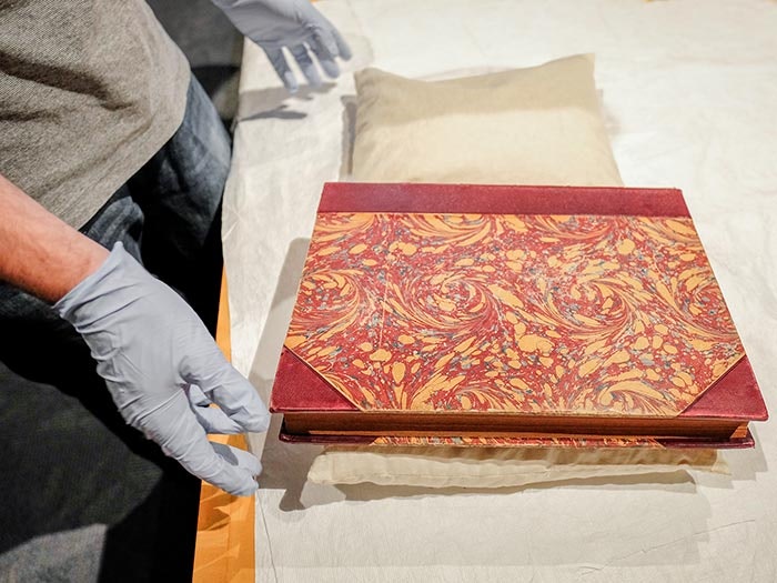 Martin Lewis shows a rare marbled book cover, 2017. Te Papa marbled-cover-rare-books-te-papa-700x525.jpg