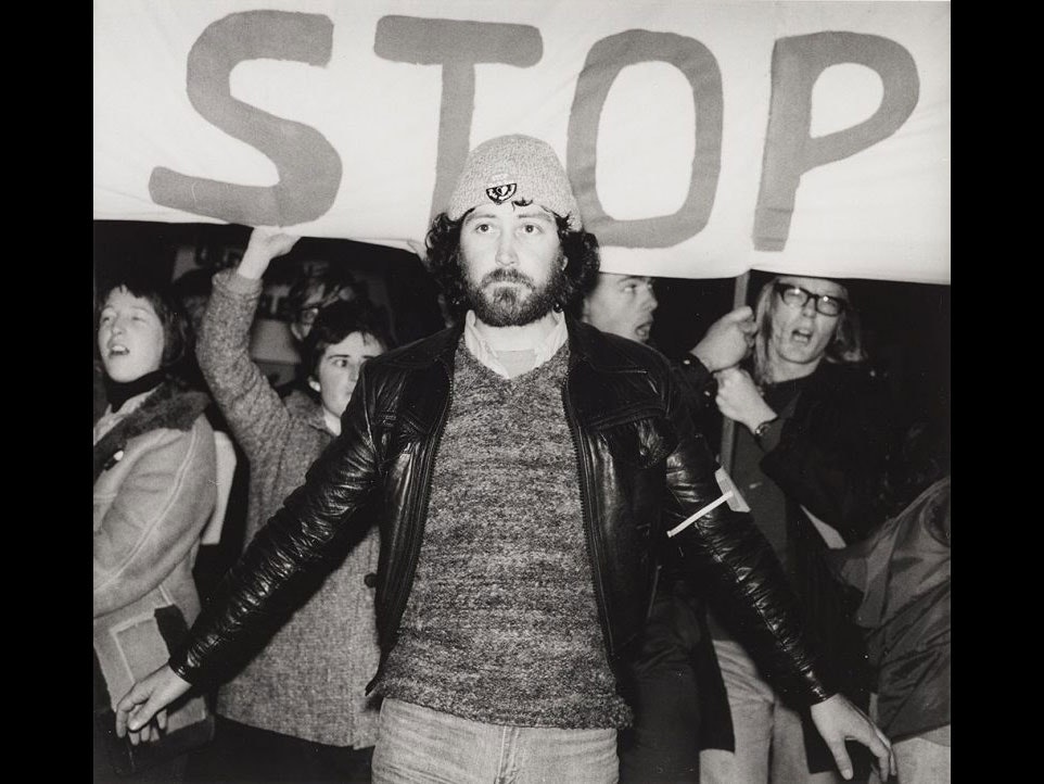 Chris McBride during an anti-Springbok rugby tour demonstration, 1981. Ans Westra, Anti Springbok tour demonstration, 1981, gelatin silver work-print. Te Papa (O.012072) A man stands in front of a sign which says 'stop'