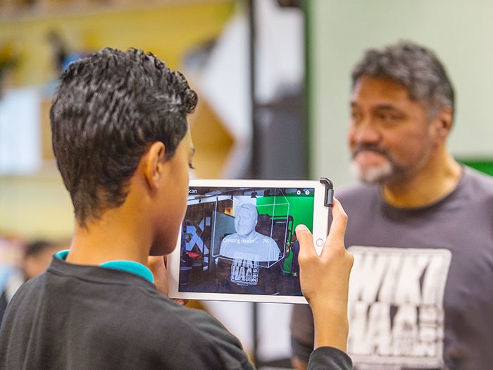 A student takes a 3D model of his teachers face