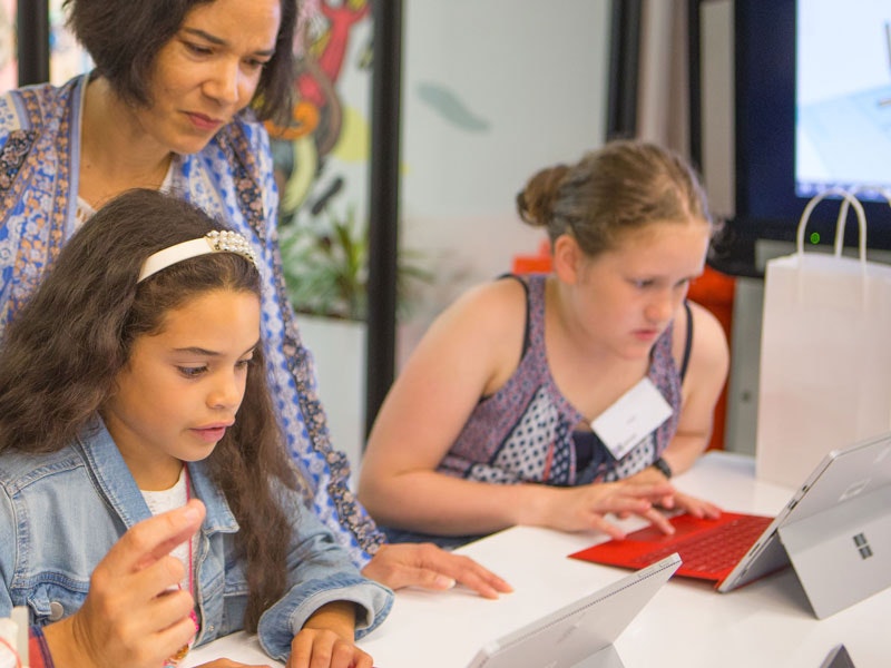 Girls with their mums coding