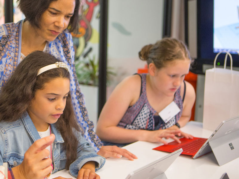 Girls with their mums coding