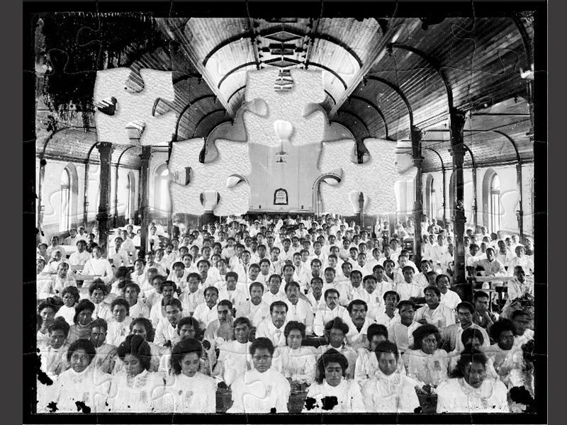 Black and white photo of Sāmoan people dressed in white in a wooden church with high arches.