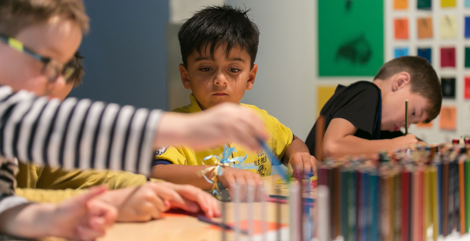 Children explore activities on offer at a table