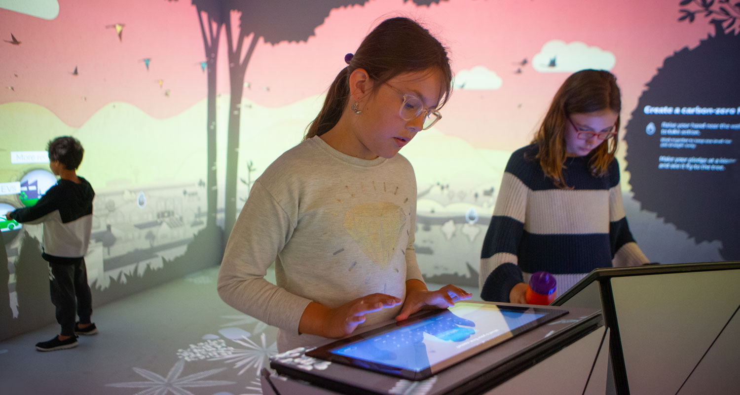 Children play with a digital interactive