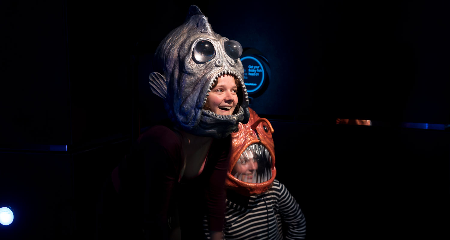 Children pose instead scary models of deep-sea fishes