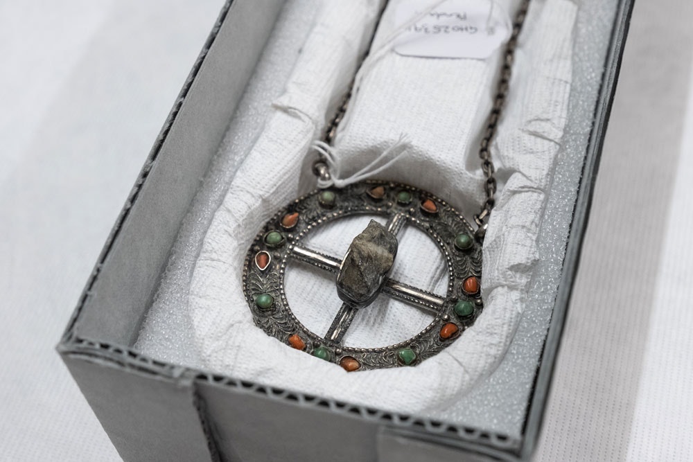 Silver pendant with a rock in the middle