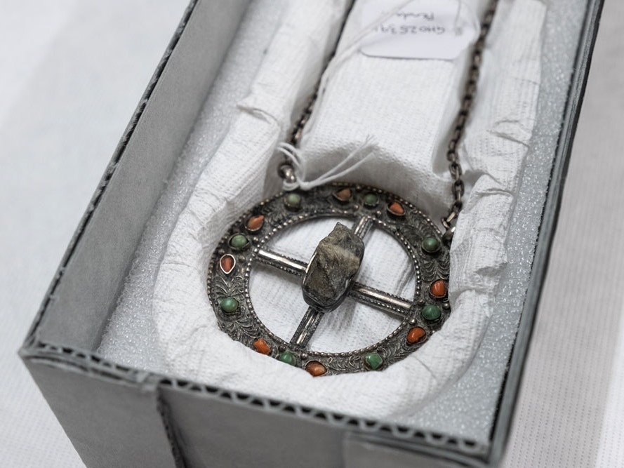 Pendant, 1953, maker unknown, Nepal. Purchased with support from Perpetual Guardian and an anonymous donor, 2019. Te Papa. (GH025391) Silver pendant with a rock in the middle