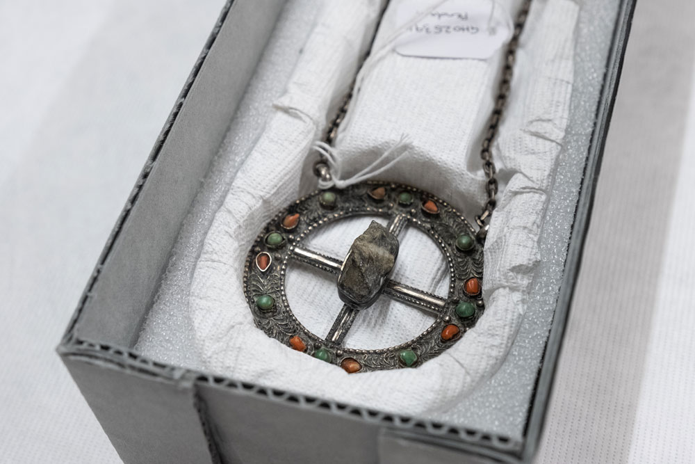 Silver pendant with a rock in the middle
