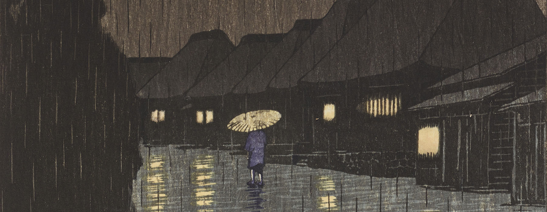 Person walks down a path in heavy rain, flanked by very tall trees on the left and houses with their lights on to the right