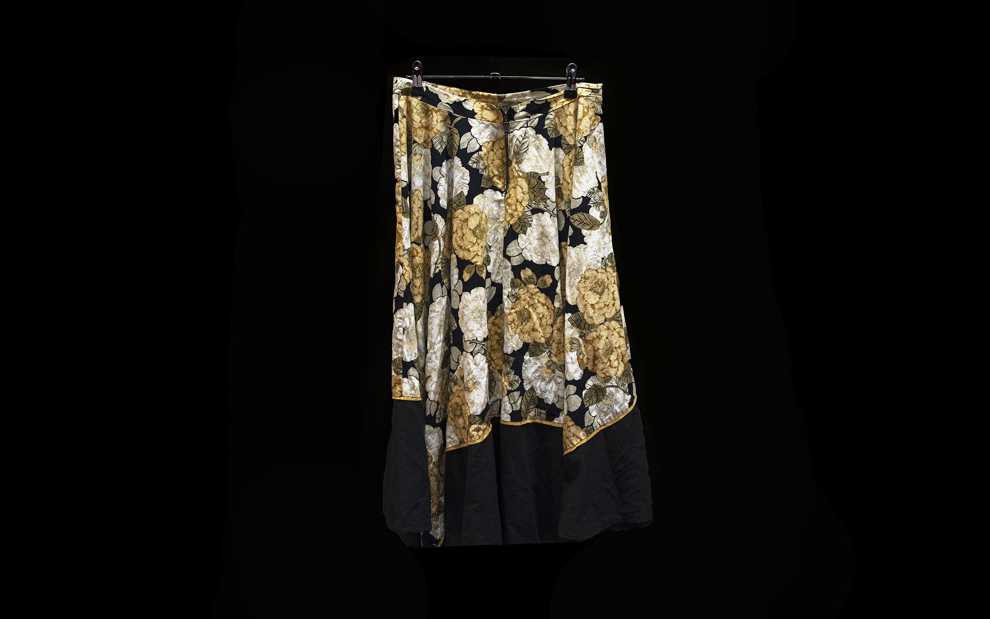 A skirt covered in green, white, and yellow flowers