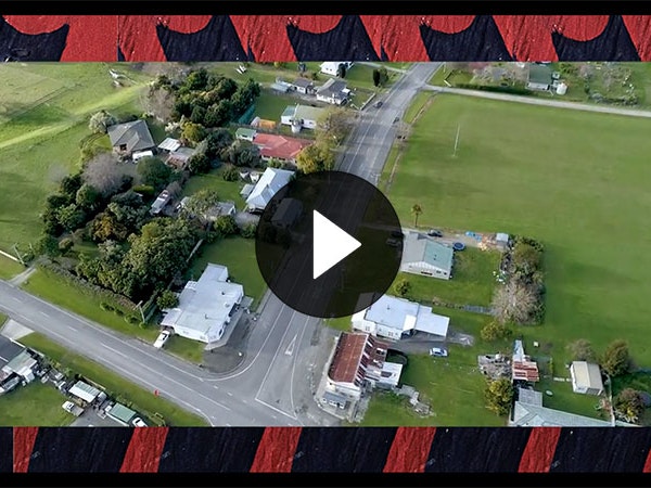 Still from video The Treaty: Solution or saviour?, by Rongowhakaata Iwi Trust, 2020. Courtesy of Rongowhakaata Iwi Trust Still from video showing overheard shot of a town, the video footage is frames by carving of a Māori motif