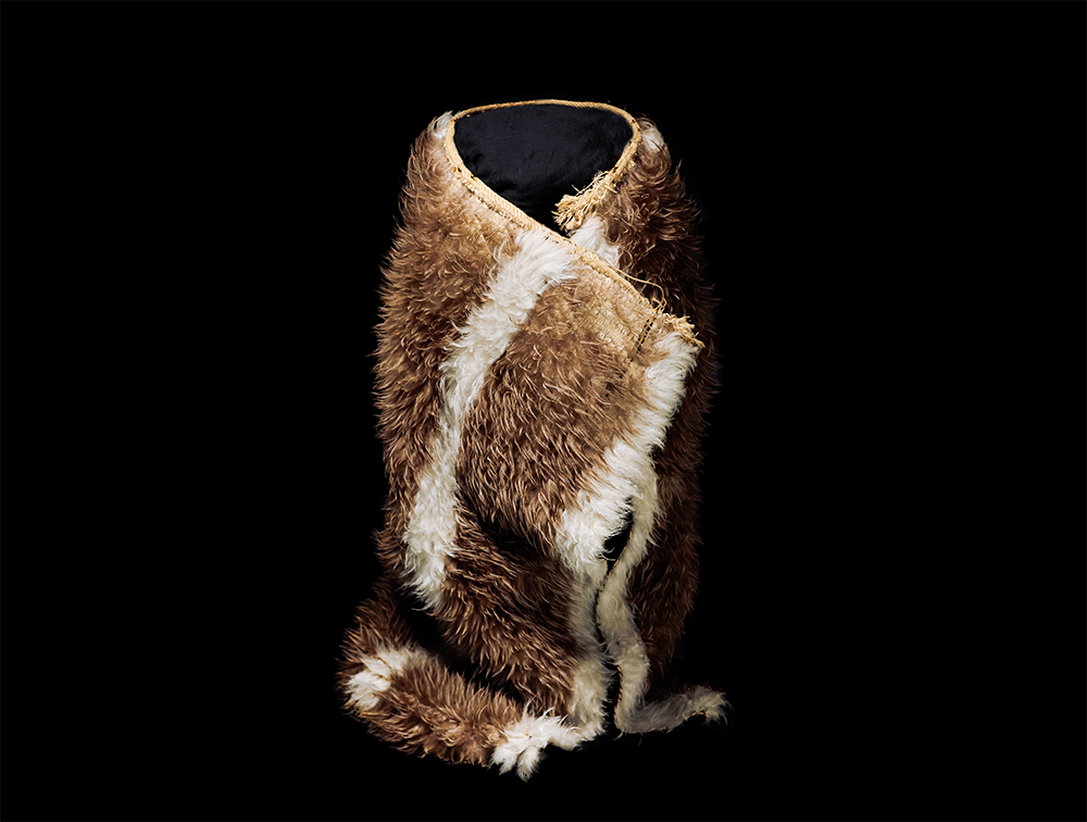 Brown cloak made of feathers on a stand