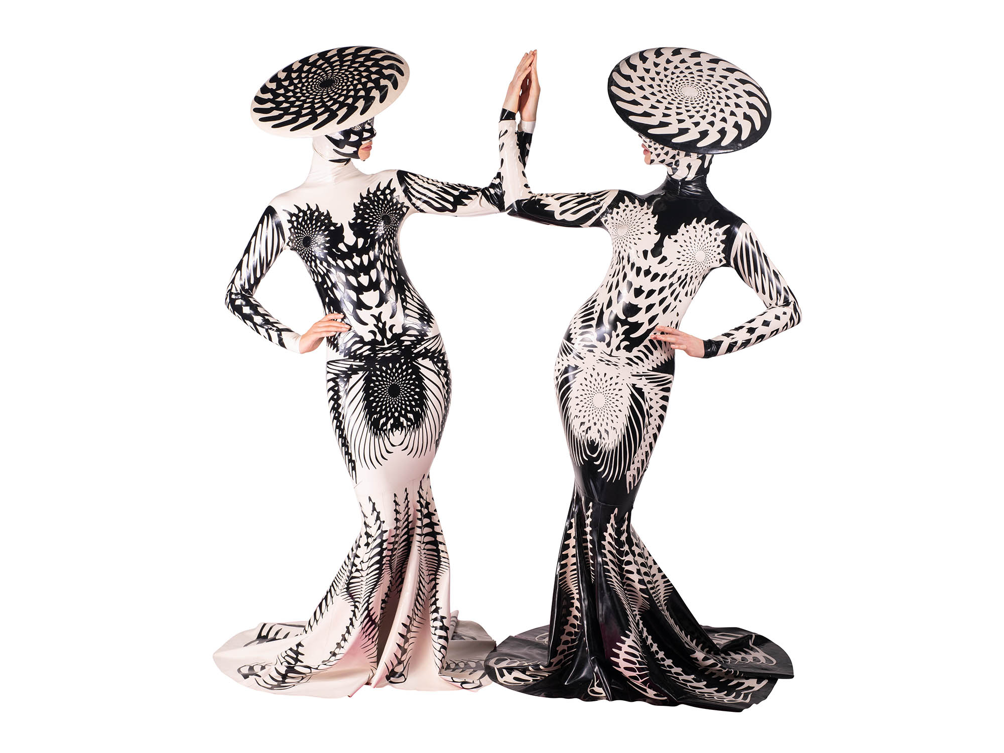 Two people in black and white costumes on a white background