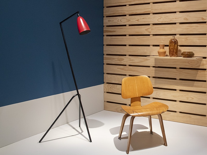 a lamp, and a chair on a blue and wooden platform