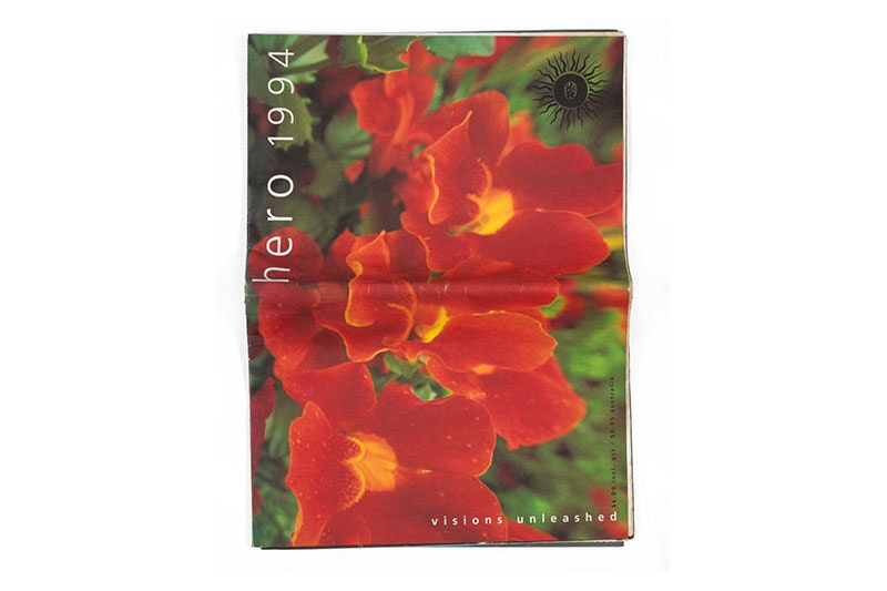 Large-scale printed paper magazine titled Hero 1994 with 'visions unleashed' along the bottom right edge. Featuring colour photograph of orange flowers against green leaves.
