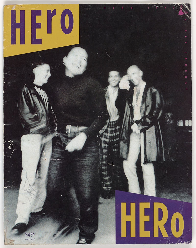 Photograph of a magazine. The cover is dominated by a black and white photo of four people standing casually, laughing. In the top-left corner is the word Hero in purple on yellow, with the opposite (Hero in yellow on purple) in the bottom right corner.