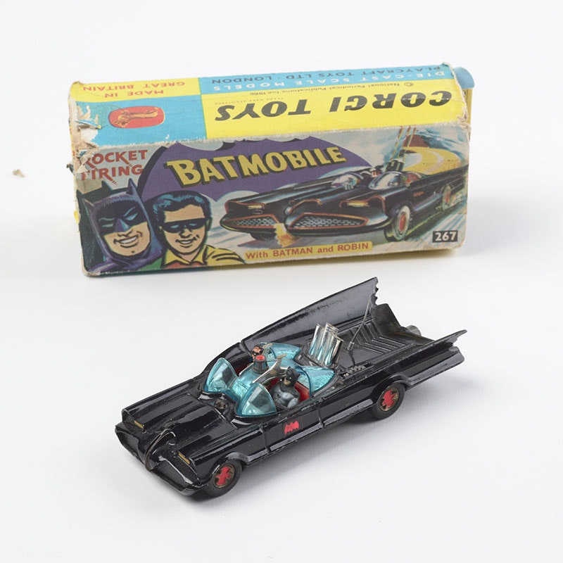 Photograph of a toy Batmobile. Behind it sits the box it came in
