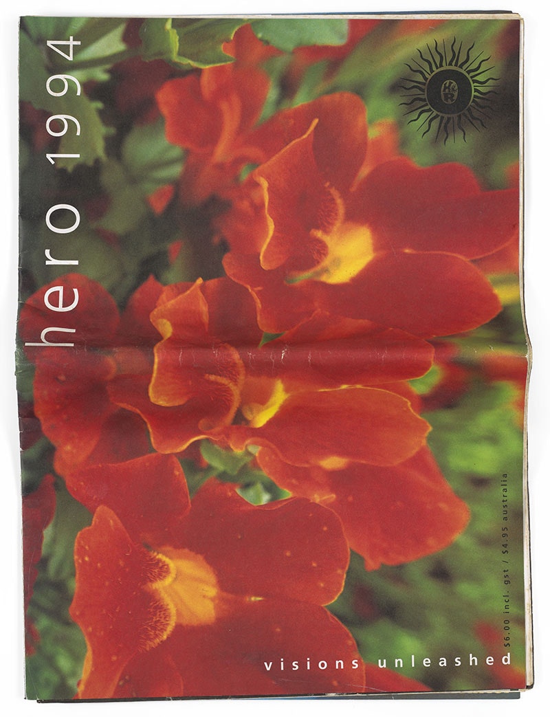 Large-scale printed paper magazine titled Hero 1994 with 'visions unleashed' along the bottom right edge. Featuring colour photograph of orange flowers against green leaves.