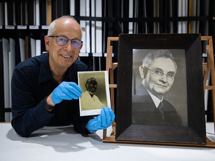 Curator Athol McCredie, 2020. Photo by Jack Fisher. Te Papa Curator Athol McCredie holds up the negative of the photo of Michael Joseph Savage