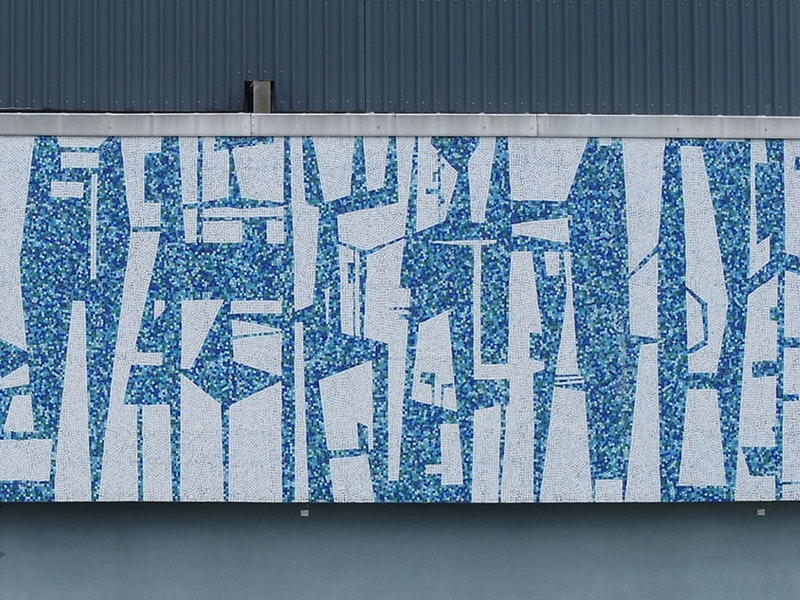 A blue and white mural on the outside wall of a building