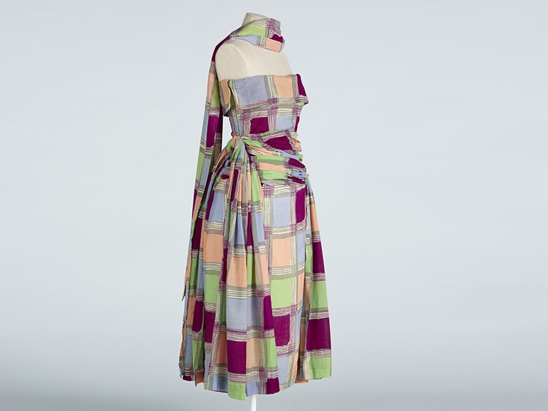 a multi-coloured dress on a dummy with a stole around the neck of the same material