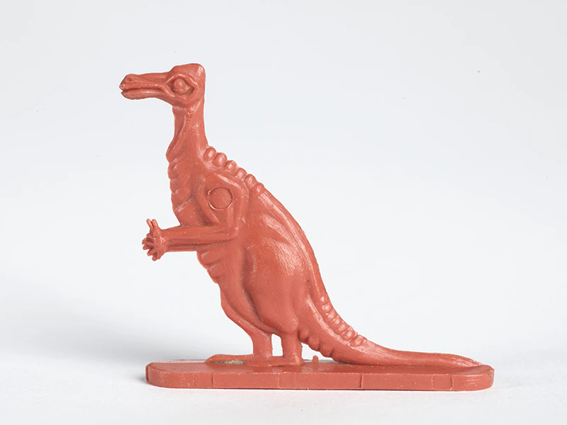 An orange plastic dinosaur that came in a cereal box in the 60s