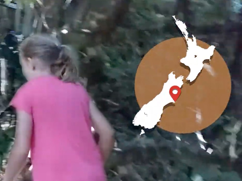 A girl in a pink tshirt is walking off screen and there's a map of New Zealand overlaid on the top right